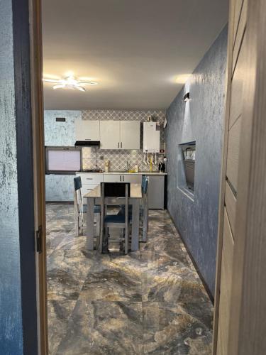 a kitchen with a table and chairs in a room at Shahdag Berghoff House in Qusar