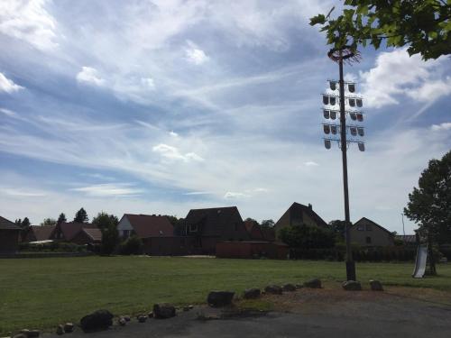 a pole with lights on it in a field with houses at Hotel Restaurant Körber in Osterwald Unterende