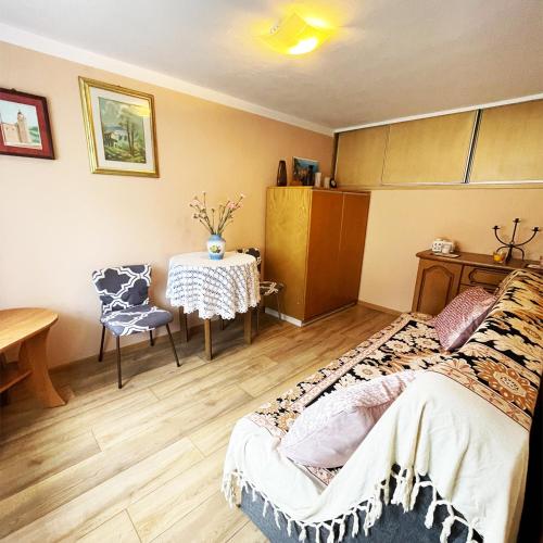 a bedroom with a table and a bed and a table and chairs at Apartament Economy in Maków Podhalański