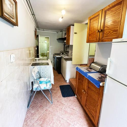 a small kitchen with a table and a refrigerator at Apartament Economy in Maków Podhalański