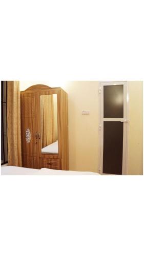 a mirror in front of a room with a door at Hopeland Villas in Msaranga