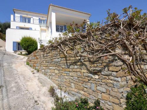 a stone wall in front of a house at Villa in Finikounta near Sandy Beach in Finikounta