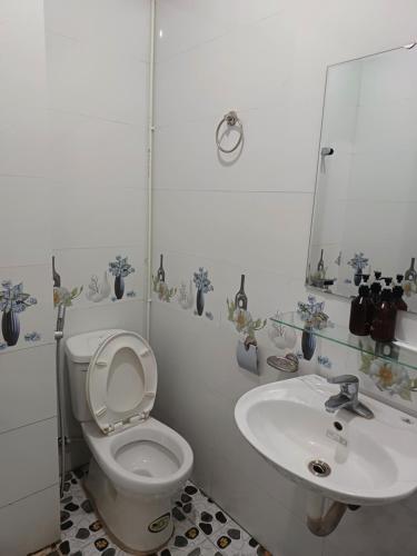 a bathroom with a toilet and a sink at Yolo Ha Giang Bus Station Stay, Motorbike & Loop Tours in Ha Giang
