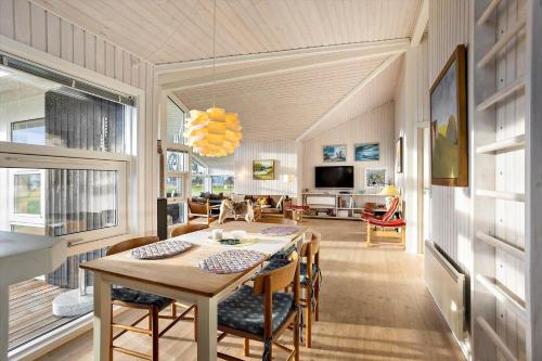 a dining room and living room with a table and chairs at AE227-Soby-Aero-Lebymarksvej-3 in Leby