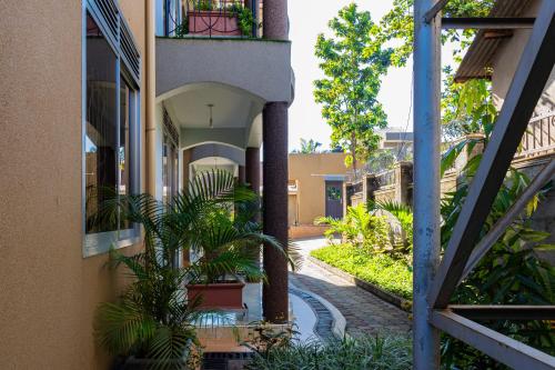 an empty courtyard of a building with plants at Pitta Opulent Apartments in Kampala
