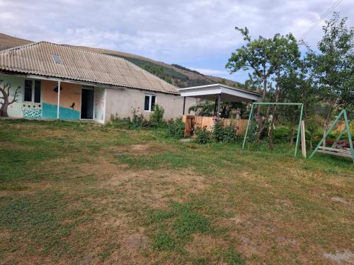a house with a soccer field in front of it at Gumbati in Tsalka