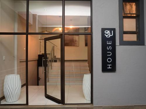 a glass door with a sign on the side of a store at Sou House in Louis Trichardt