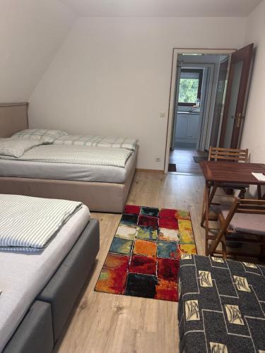 a bedroom with two beds and a rug on the floor at Jacky Wohnung in Schonwald im Schwarzwald