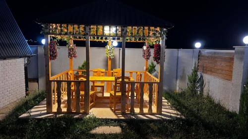 a gazebo with a table and chairs in it at A-frame evlər in Qusar