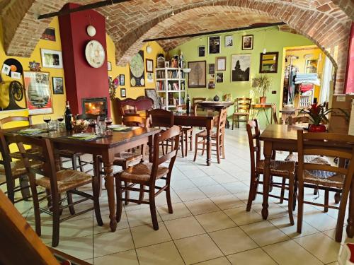 a dining room with wooden tables and chairs at Cascina Il Convivio in Diano dʼAlba