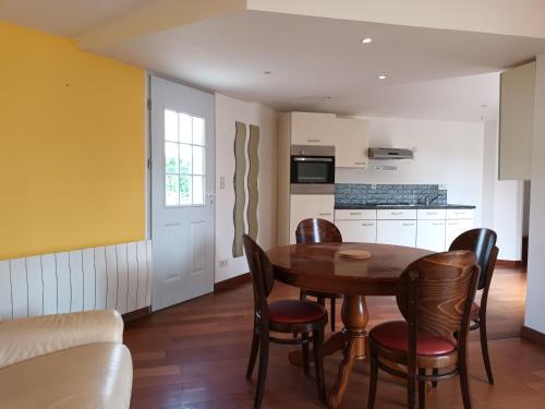 a kitchen and dining room with a table and chairs at 229 - villa de la fosse a l ane in Le Fuilet