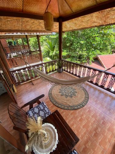 an outdoor patio with a hammock on a deck at Baan Kiao in Haad Yao