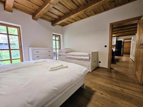 a bedroom with a large white bed and a dresser at Apartmán u Ondrucha in Velké Karlovice