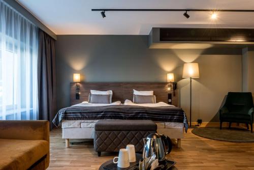 a hotel room with a bed and a couch at Scandic Infra City in Upplands-Väsby