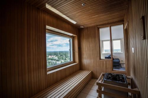 a sauna with a window and a stove in it at Scandic Infra City in Upplands-Väsby