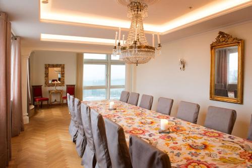 a dining room with a long table and a chandelier at Scandic Infra City in Upplands-Väsby