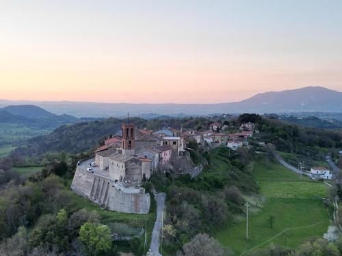 an old castle on a hill in a field at B&B Rox e Claudia in Lugnola