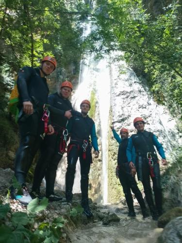 a group of people standing in front of a waterfall at B&B Rox e Claudia in Lugnola