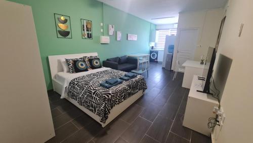 a bedroom with a bed and a couch in it at RIVERA Studios 4 in Limassol