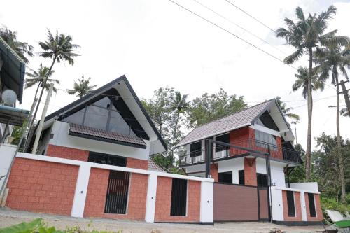 a house with a large window on top of it at Cloud Lacasa in Athirappilly