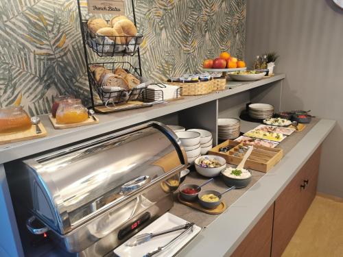 a breakfast buffet with food on a counter at Gościniec nad Olzą in Cieszyn