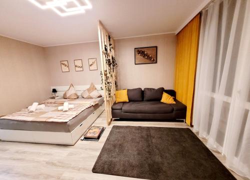 a living room with a bed and a couch at Modernes Wohlfühl-Apartment mit Stil in Mülheim an der Ruhr