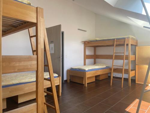 a room with three bunk beds in a room at Ostello Cresciano in Cresciano