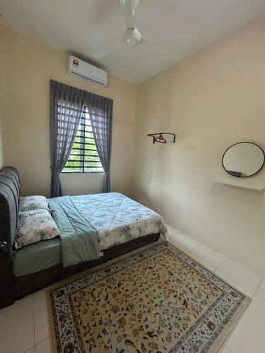 a bedroom with a bed and a window with a rug at Singgah homestay in Gua Sai