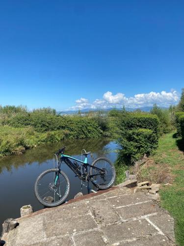 a bike parked on a bridge over a river at Casa Barbara in Sant Arcangelo