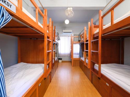 a room with four bunk beds and a hallway at Pak-Up Hostel in Krabi town