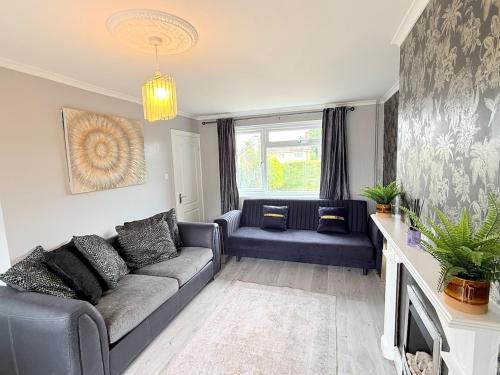 a living room with a couch and a fireplace at Home in between Bath and Bristol - Sleeps 9 guests in Keynsham