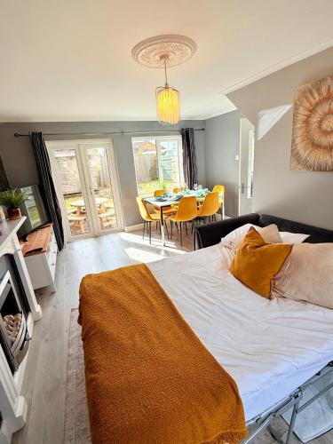 a bedroom with a bed and a dining room with a table at Home in between Bath and Bristol - Sleeps 9 guests in Keynsham