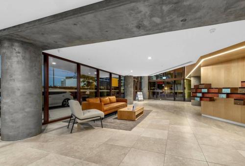 a living room with a couch and a chair at 2BR Apt in Proximity Hamilton with Carpark in Brisbane