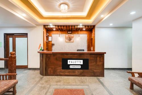 a bar in a room with a podium at Palette Bhimpore Daman Formerly Hotel Hilltop in Daman