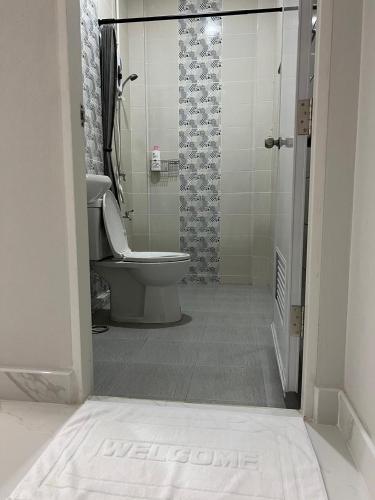 a bathroom with a toilet and a shower at ADNA Family Room near Dannok 1 Mins to Lotus Sadao 