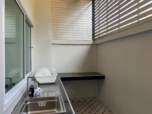 a kitchen with a sink and a window with blinds at ADNA Family Room near Dannok 1 Mins to Lotus Sadao 