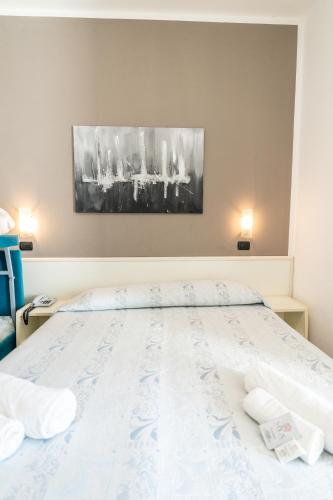 a bedroom with a bed with two pillows on it at HOTEL CONTI in San Mauro a Mare