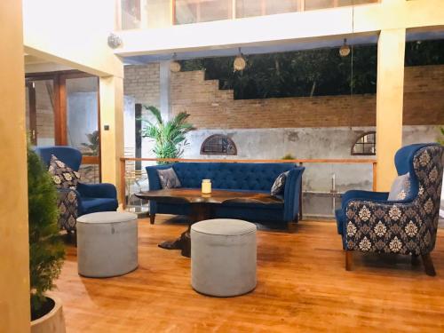 a lobby with a blue couch and two chairs and a table at Villa Penalty 2 in Boralesgamuwa