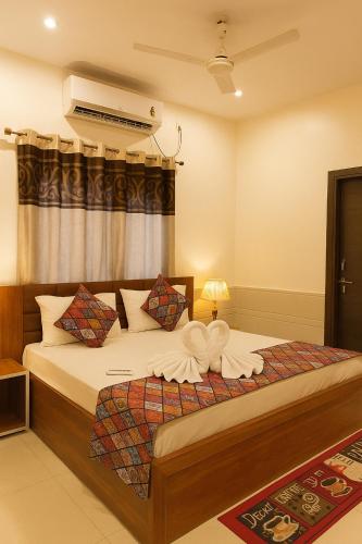 a bedroom with a large bed with white sheets at Shri Radha Kunj Vrindavan in Vrindāvan