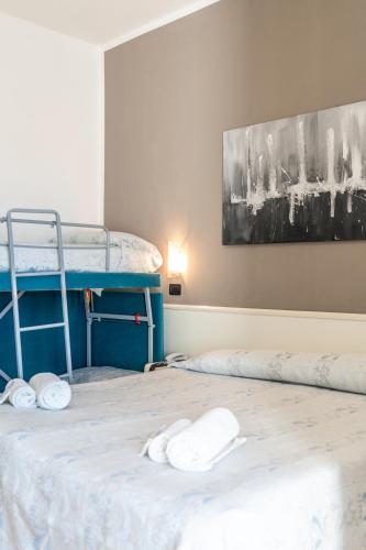 a room with two bunk beds with towels on the bed at HOTEL CONTI in San Mauro a Mare