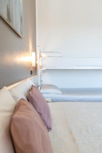 a bedroom with a bed with a window and a pillow at HOTEL CONTI in San Mauro a Mare