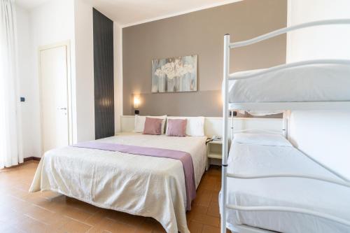 a bedroom with two beds and a bunk bed at HOTEL CONTI in San Mauro a Mare