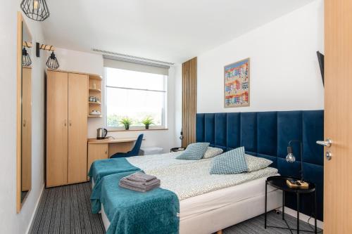 Ένα ή περισσότερα κρεβάτια σε δωμάτιο στο Sapphire Hotel Room Poznan