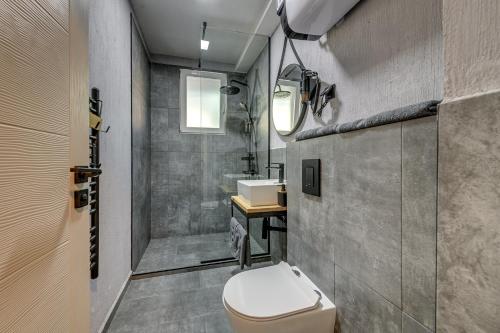 a bathroom with a toilet and a sink at La Shara Building in Sofia