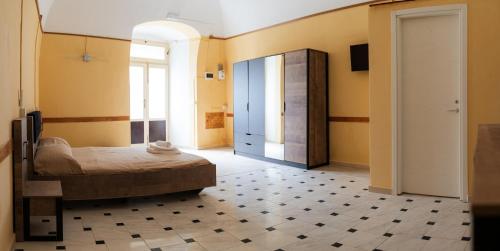 a bedroom with a bed in a room with yellow walls at Santi Medici 2 in Grumo Appula
