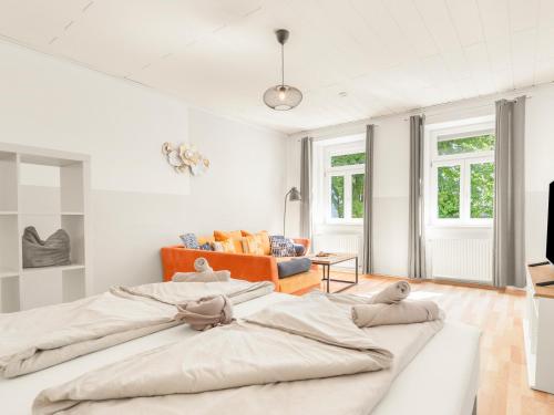 a white room with two large beds in it at Stilvolle Gartenwohnung im Villenviertel Villachs in Villach
