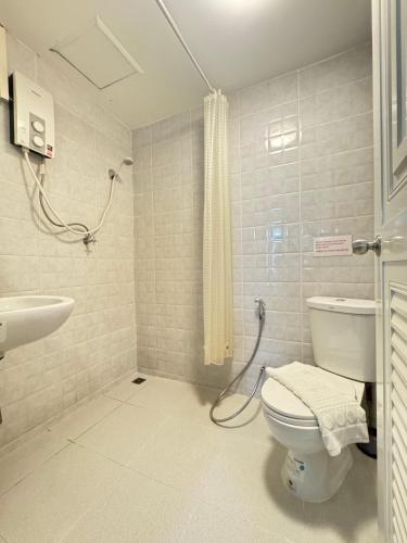 a bathroom with a toilet and a sink and a shower at La Casa Patong in Patong Beach