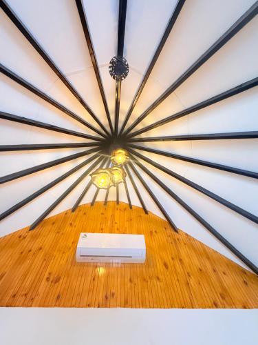 a ceiling with a light in the middle of a room at Tribal Village in Trincomalee