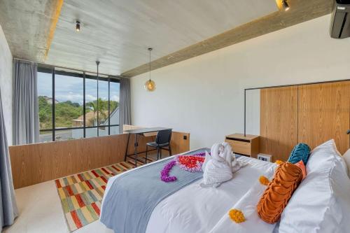 a bedroom with a bed with stuffed animals on it at Tegeh Townhouse Complex Modern 1BR In Uluwatu in Ungasan