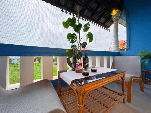 a table with a plant in a room with a window at Nestwood - By The Beach Goa in Benaulim